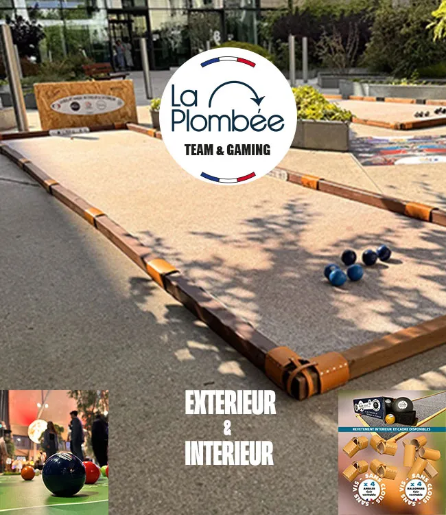 Terrain de pétanque La Plombée installé en intérieur et en extérieur, avec boules et cochonnets en situation de jeu.